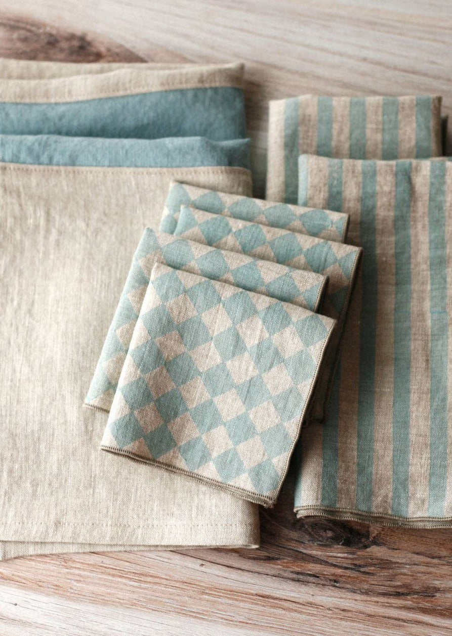 Table With Multiple Types Of Napkins, and Four Diamond Cocktail Napkins Folded on Top