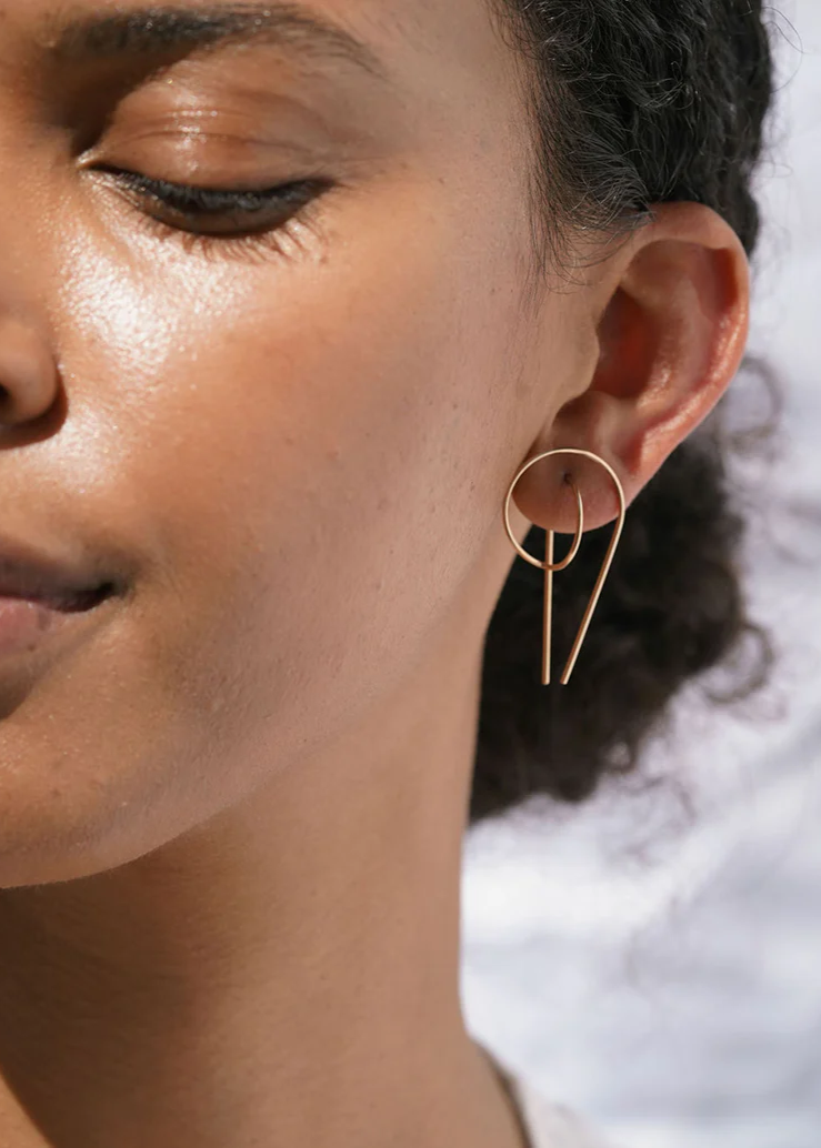 Gold gravity hoops by Baleen shown on a model