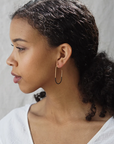 Gold Tulip Hoops by Baleen worn by a model