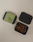 Incense box one closed stating "Desert Kush" and one opened next to it on a cream background