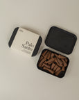 Incense box one closed stating "Palo Santo" and one opened next to it on a cream background