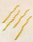 Flatlay of a yellow wavy reusable straw.
