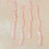 Flatlay of a pink wavy reusable straw.