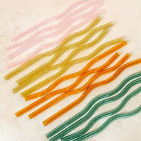 Flatlay of colorful wavy reusable straws.