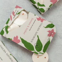 Close-up of jasmine and amber shower steamer boxes surrounding