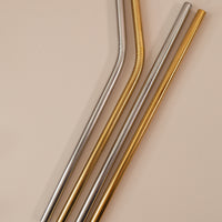 flatlay of reusable straws in silver and gold