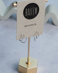 Silver hoop earrings on a 'Baleen' branded card on a light gray background