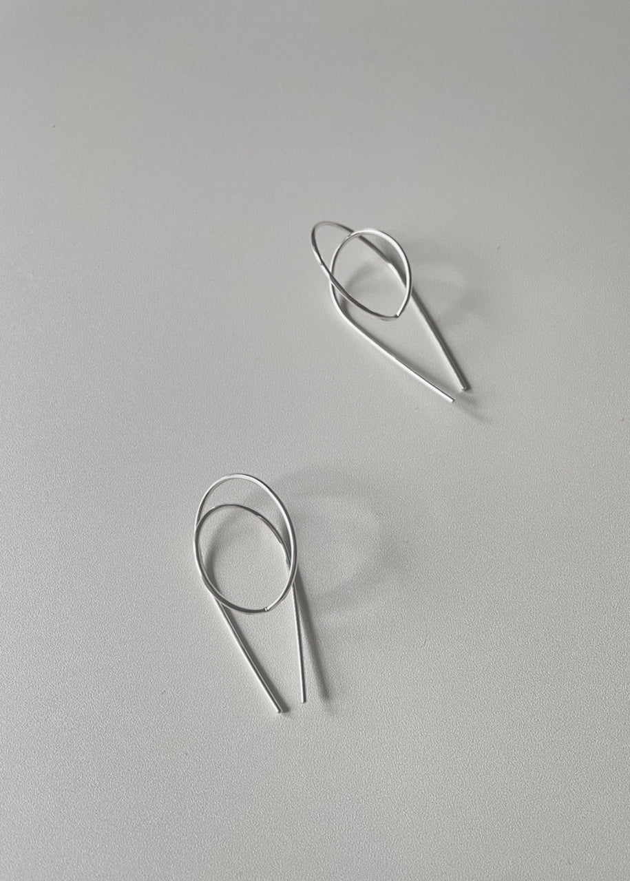 flay lay of silver gravity hoops by Baleen