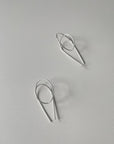 flay lay of silver gravity hoops by Baleen