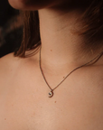 Crescent moon necklace by Claire Sommers Buck shown on model