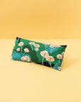 eye pillow with green and blue shades with pink mushrooms on it.