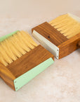 close up photo of two dust pan sets, one white farther away and the mint set closer to the camera.