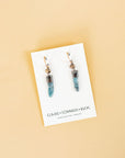 White jewelry card with two Akh earrings from Clair Sommers Buck