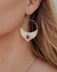 Madrasa hoop earrings with red stones by Claire Sommer Buck shown on model.