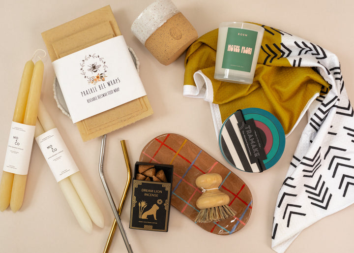 Flatlay of indie, sustainable home goods such as beeswax wraps, incense with essential oils, and reusable napkins