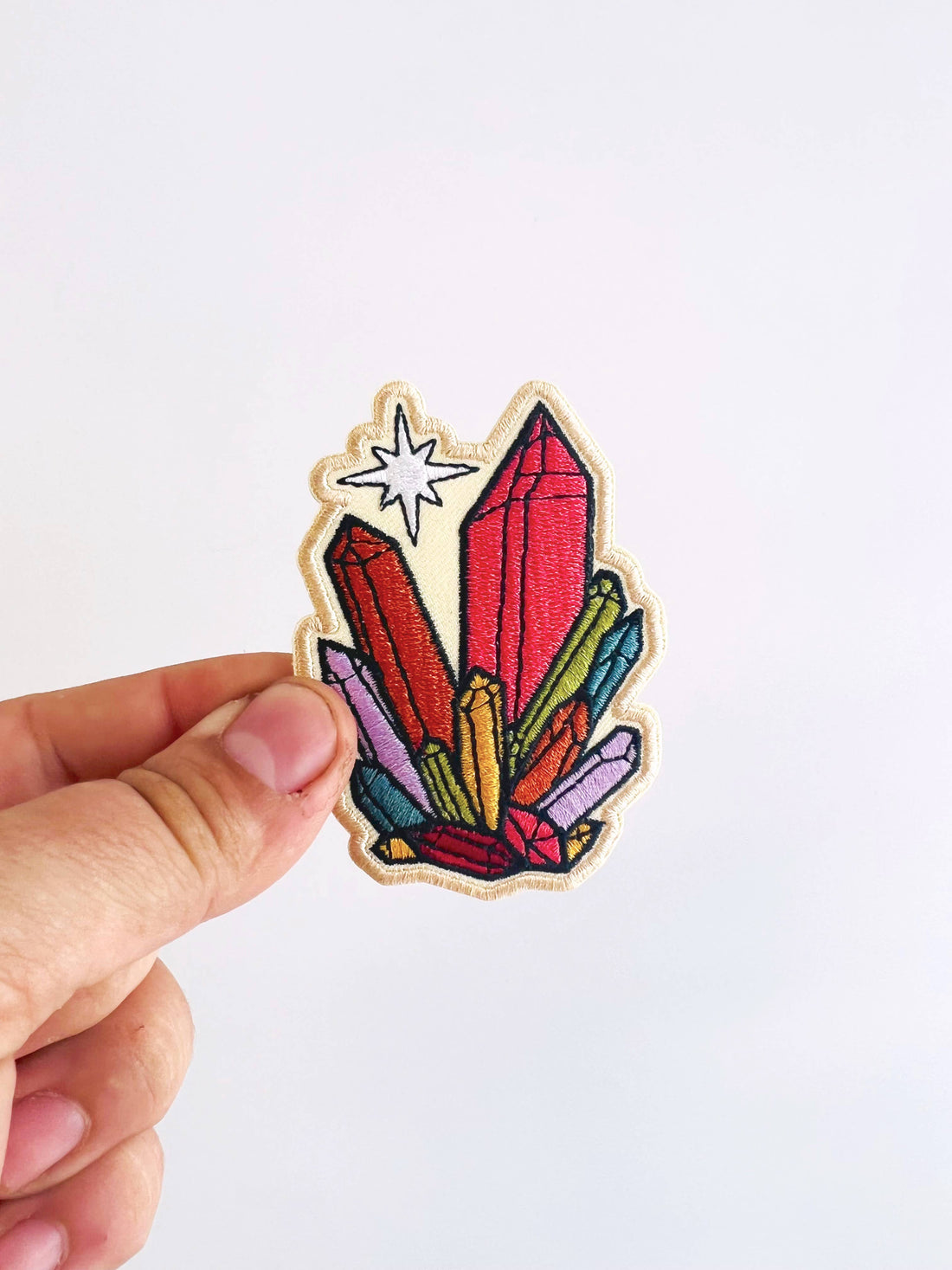 Model holding Rainbow Crystals Embroidered Iron-On Patch
