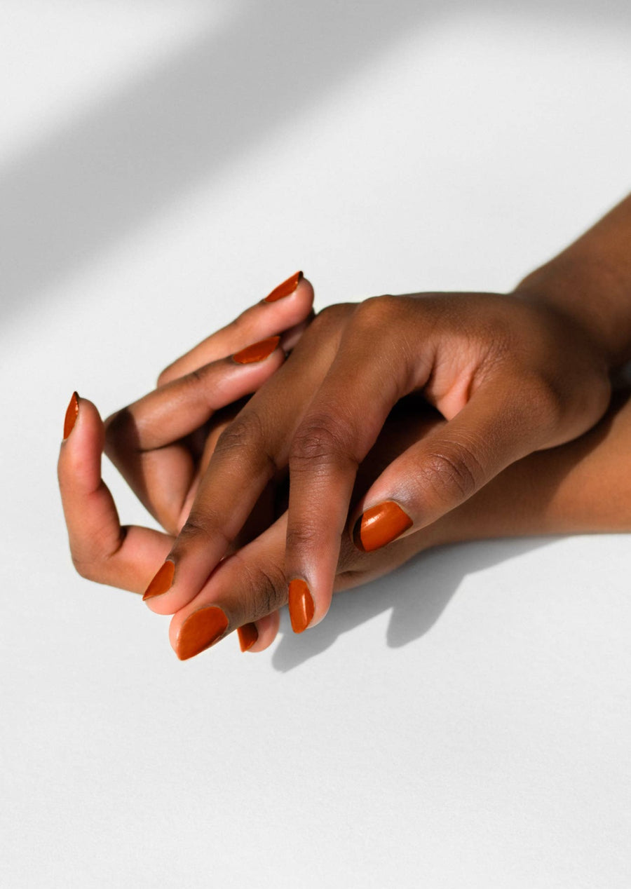Models hands with Pumpkin Spice Nail Polish on