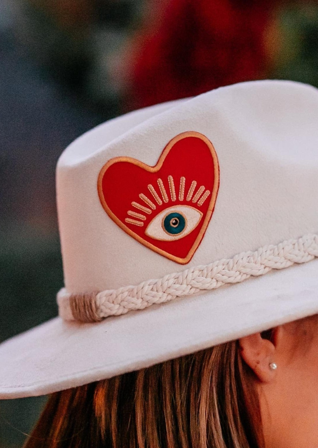 Red Heart Evil Eye Embroidered Iron On Patch On a Models Hat