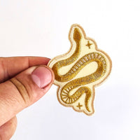 Model Holding Metallic Gold Snake Iron-on Patch