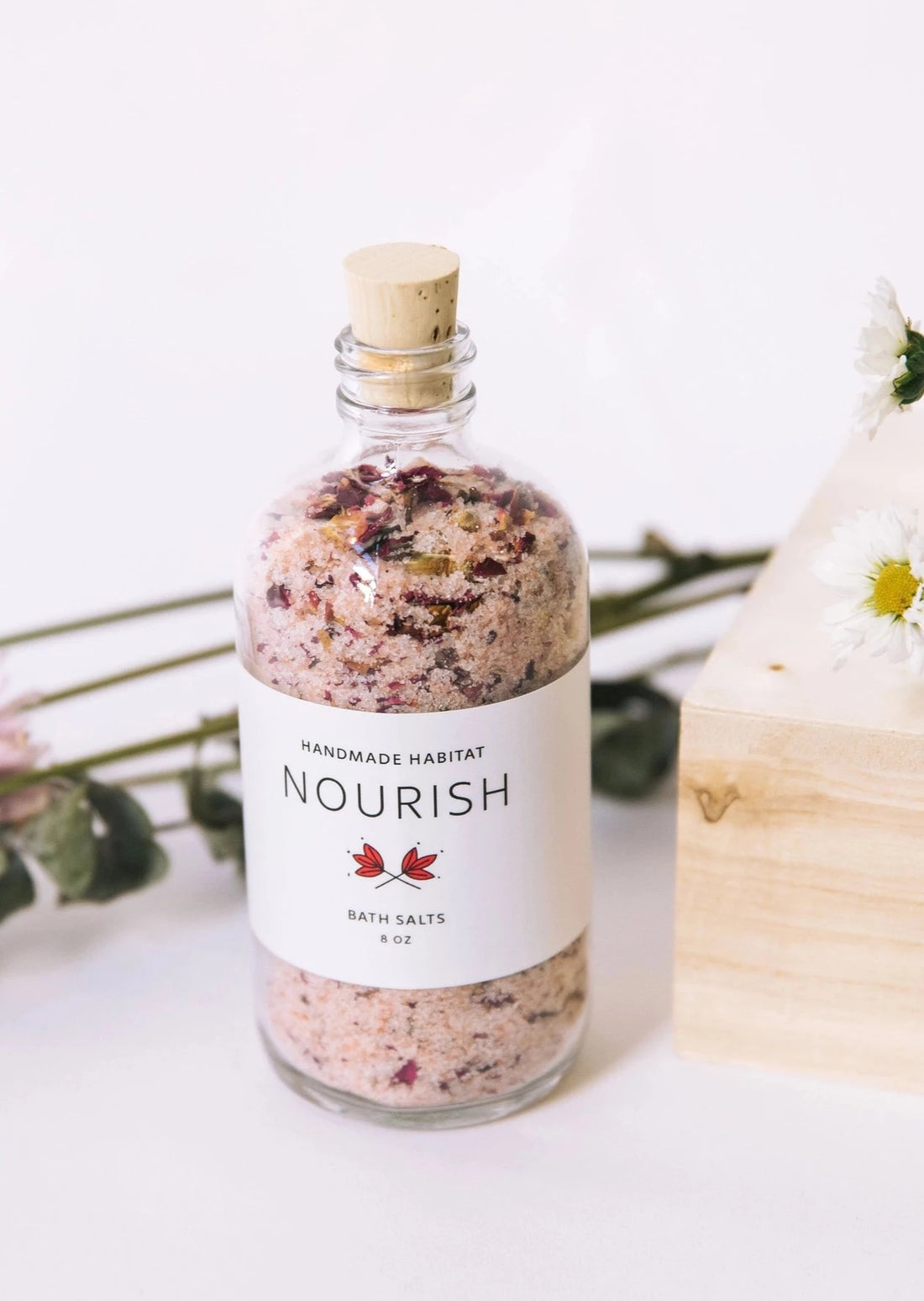Jar of Nourish Bath Salts with Flowers Surrounding