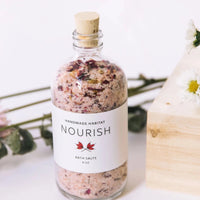 Jar of Nourish Bath Salts with Flowers Surrounding