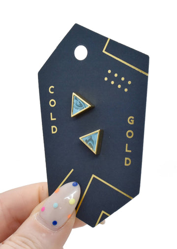 Model Holding Jewelry Card with Aquamarine Triangle Gold Studs