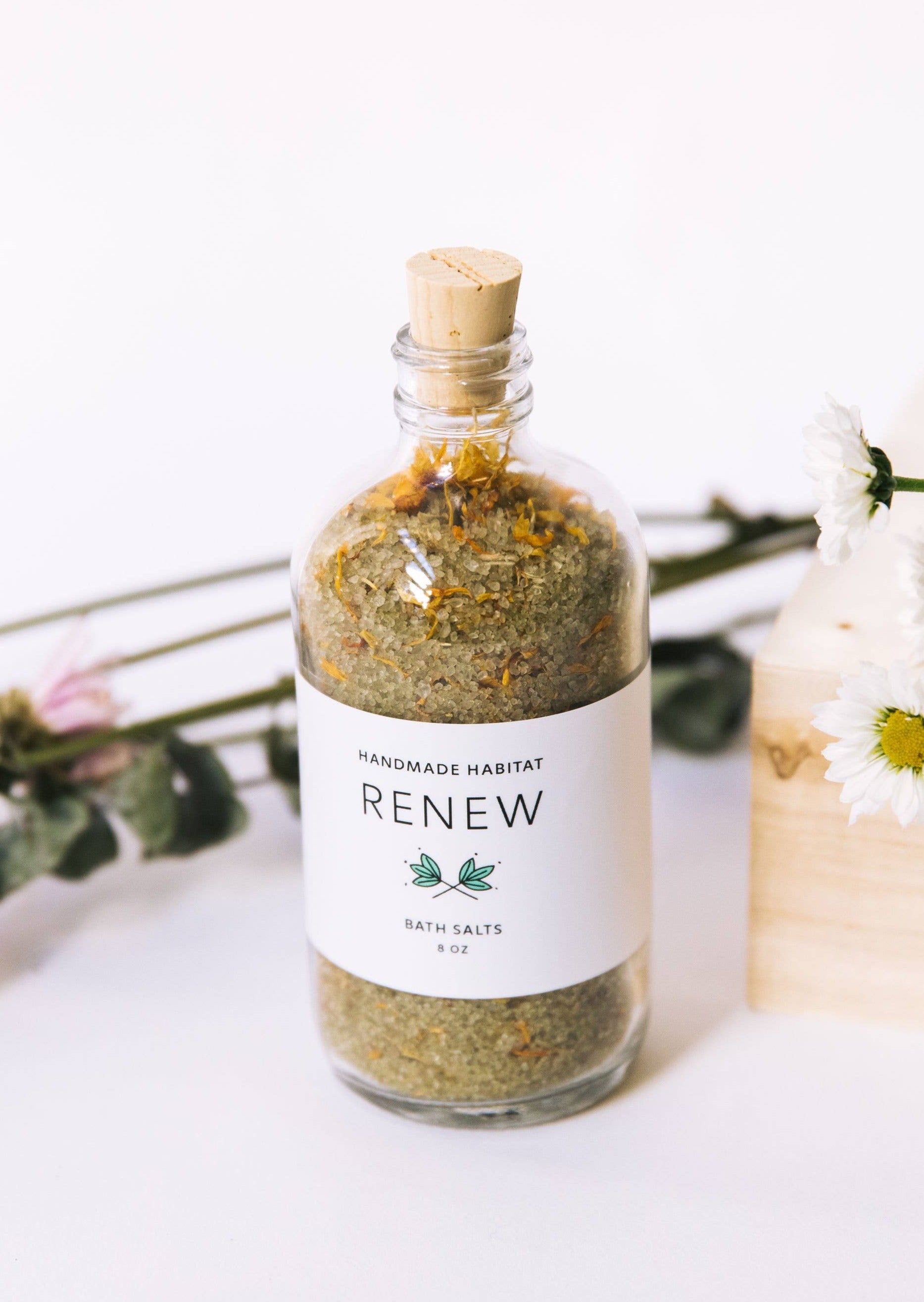 Jar of Renew Bath Salts in front of Wildflowers