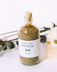 Jar of Renew Bath Salts in front of Wildflowers