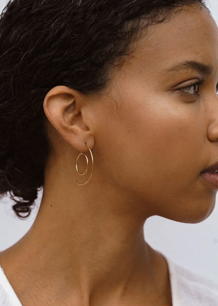 Gold deco style hoops worn by a model