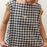 photo of a woman wearing a black and white block print shirt
