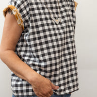 photo of a woman wearing a black and white block print shirt
