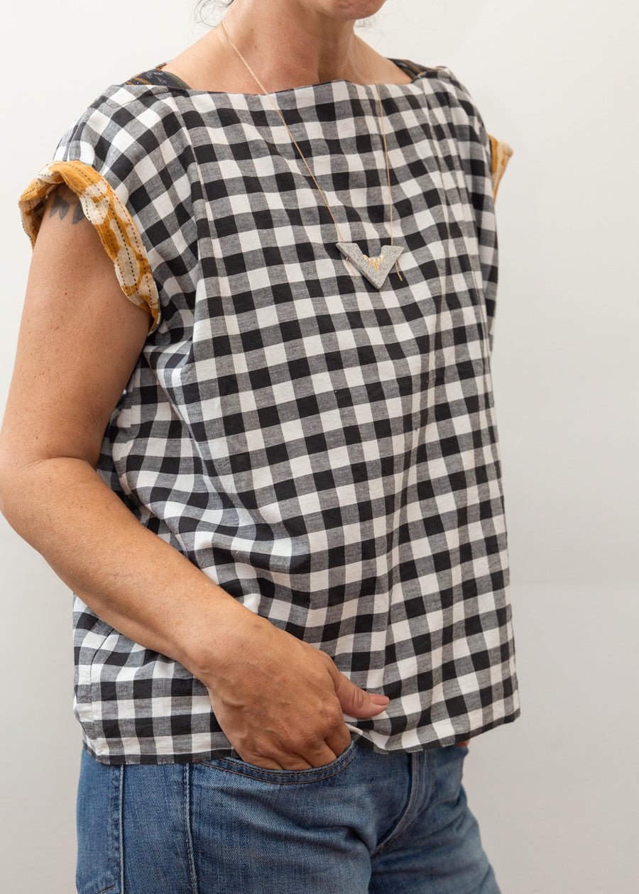 photo of a woman wearing a black and white block print shirt