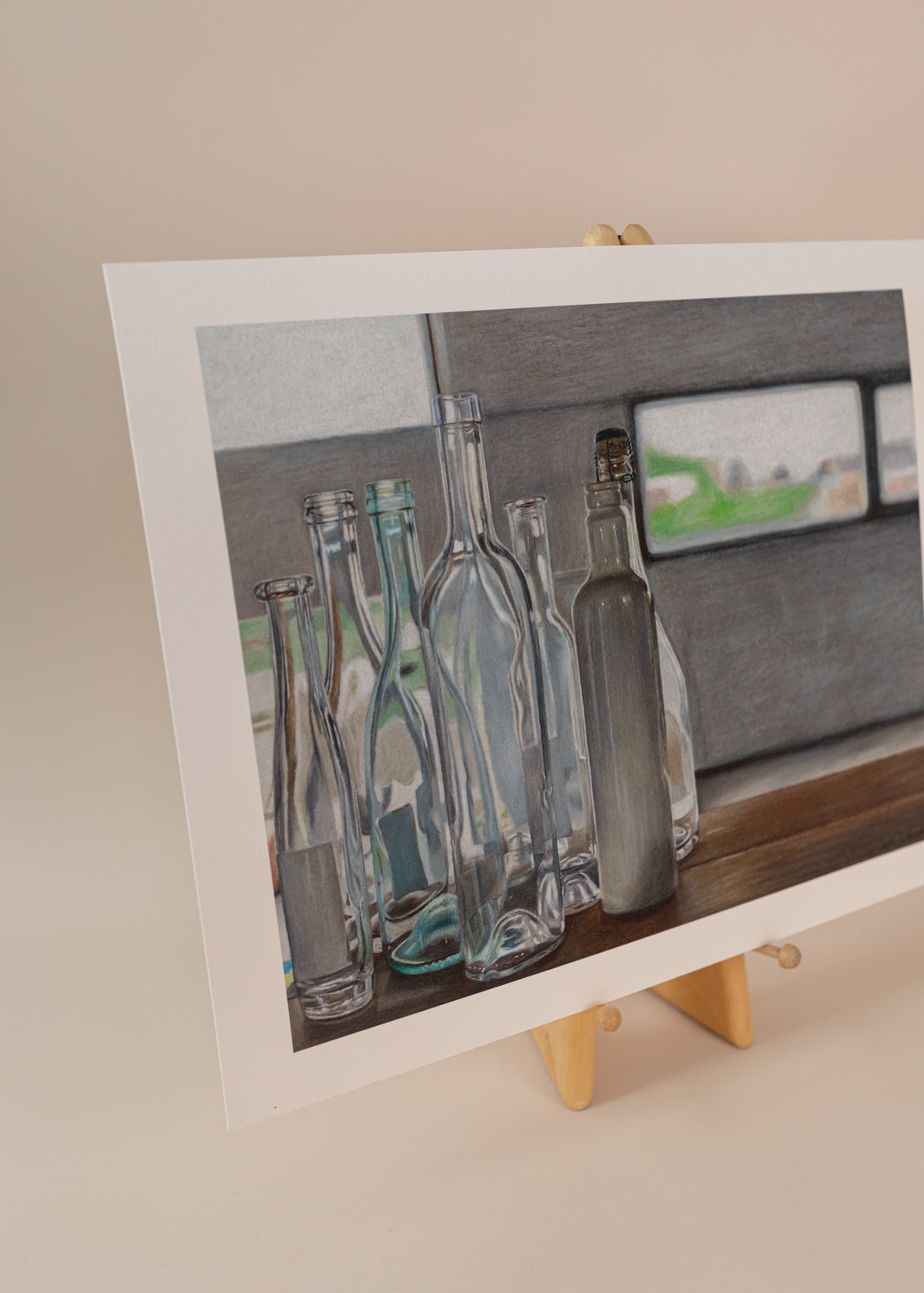 Photo of an art print with multiple glass bottles for an italian series. Standing on a easel light pink background