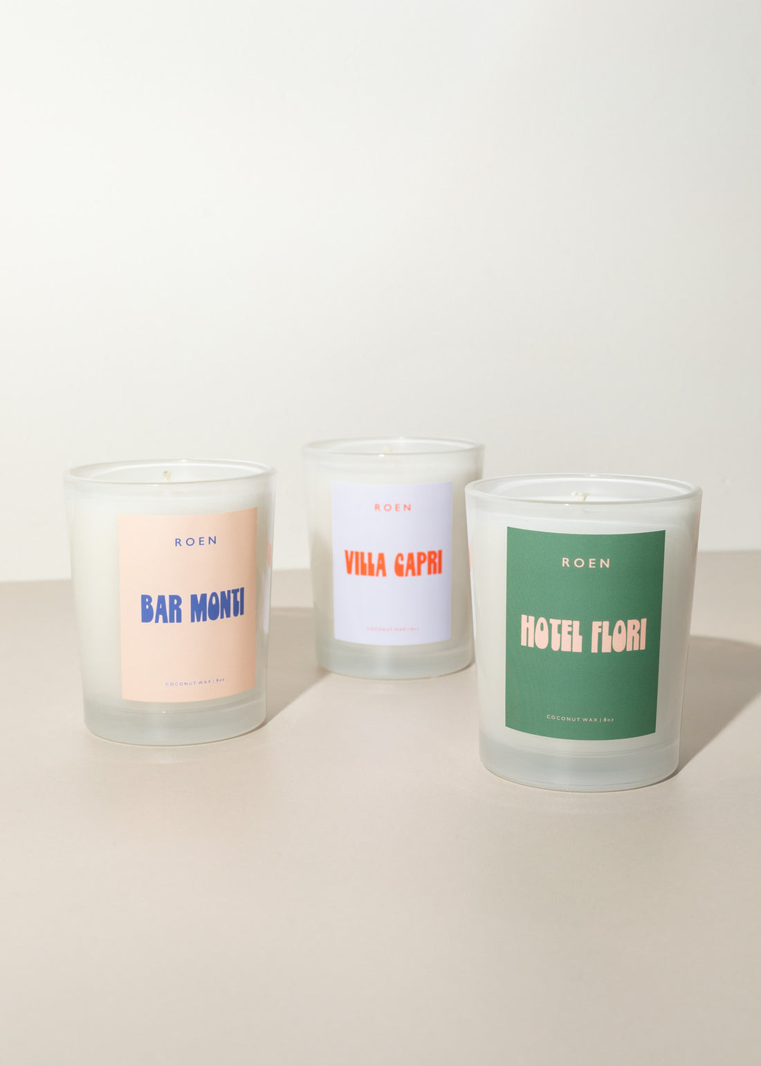 Three italian inspired candles named from left to right: Bar Monti, Villa Capri and Hotel Flori with retro inspired colors and font for the labels