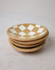 Stack of Four Checkerd White Dishes