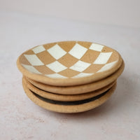 Stack of Four Checkerd White Dishes