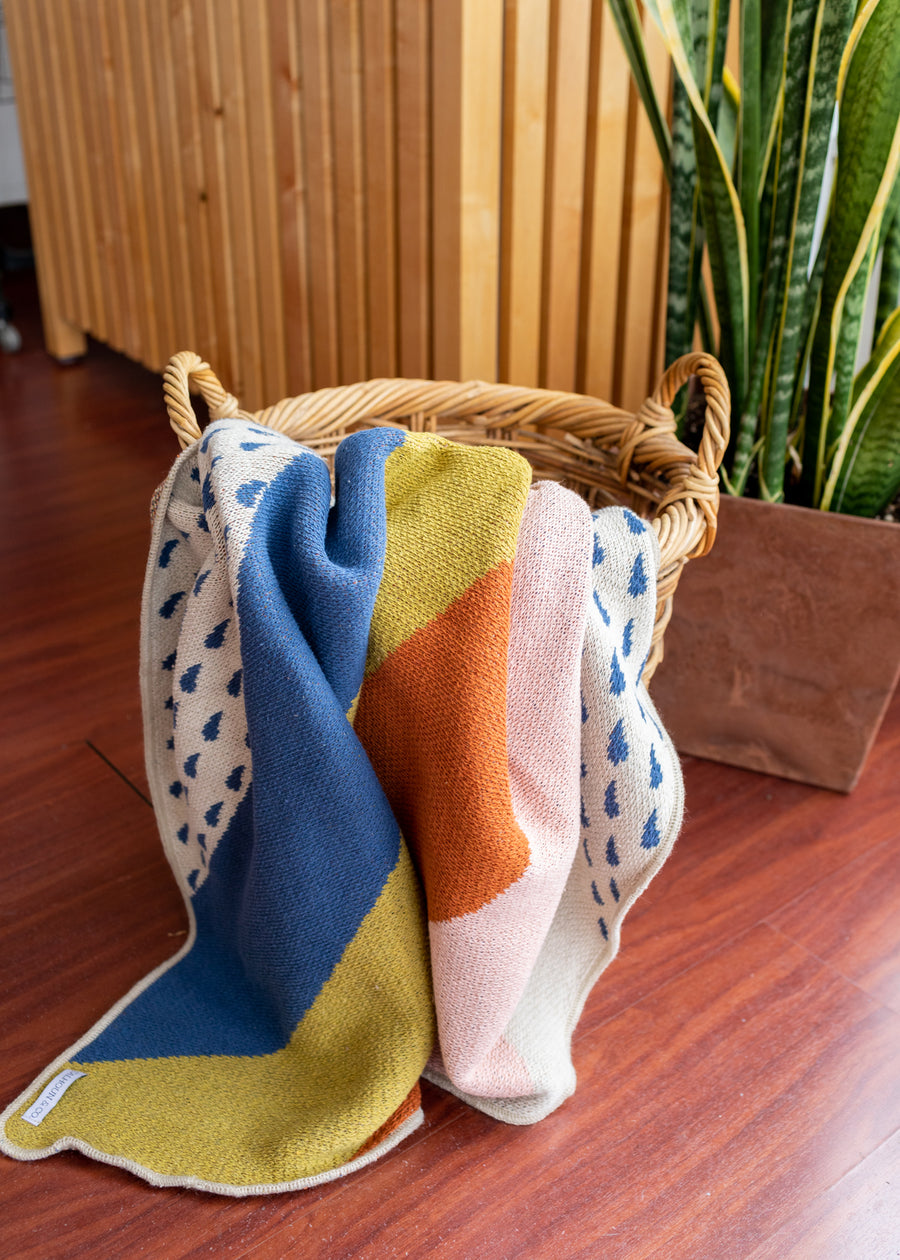 Photo of a multicolored blanket falling out of a basket