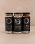 Three tall bath soak jars side to side with lavender & mint, lavender & lemongrass and rose & cardamom scents