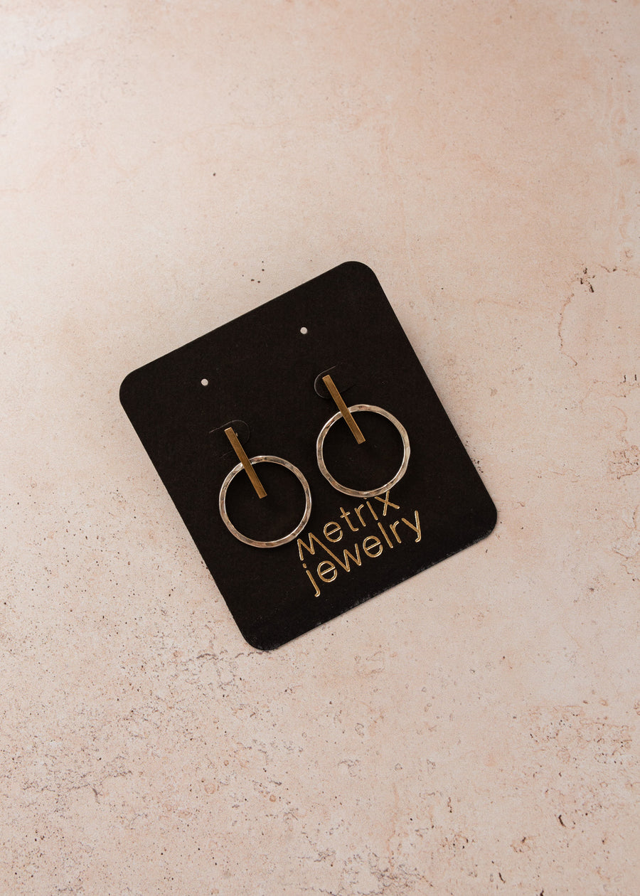 flat-lay of mixed metal earrings on a black jewelry card