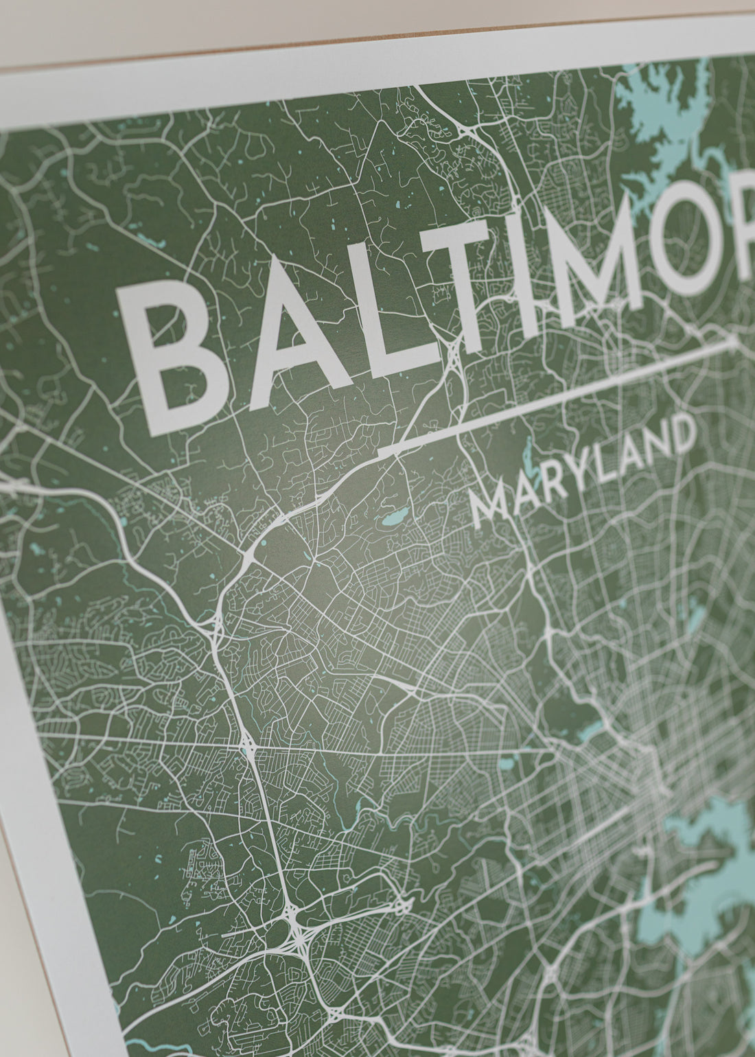 Close-up of art print of baltimore map in a sea green color