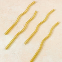 Flatlay of a yellow wavy reusable straw. 