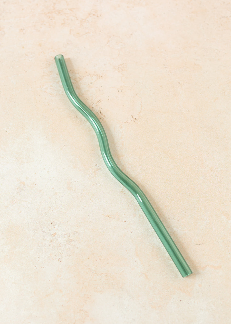 Flatlay of a teal wavy reusable straw. 