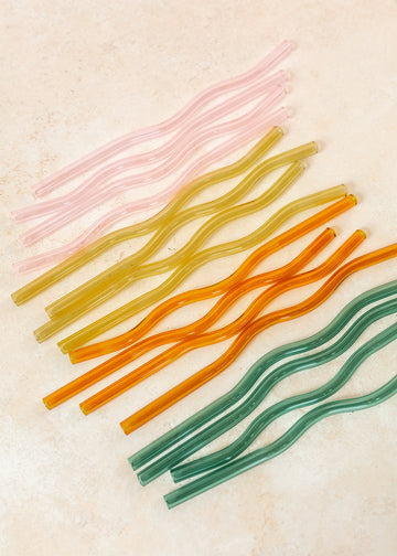 Flatlay of colorful wavy reusable straws. 