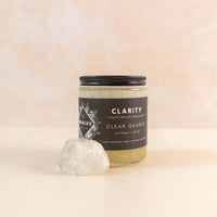 Jar of sea salt body scrub with a clear quartz on the side 