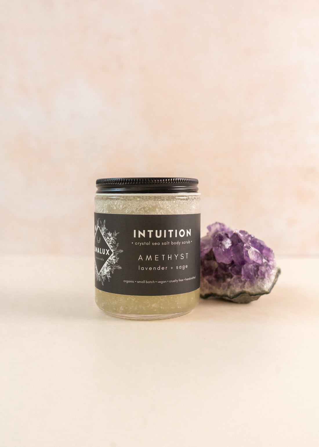 Jar of sea salt body scrub with an amethyst on the side 