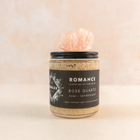 Jar of sea salt body scrub with a rose quartz on top 