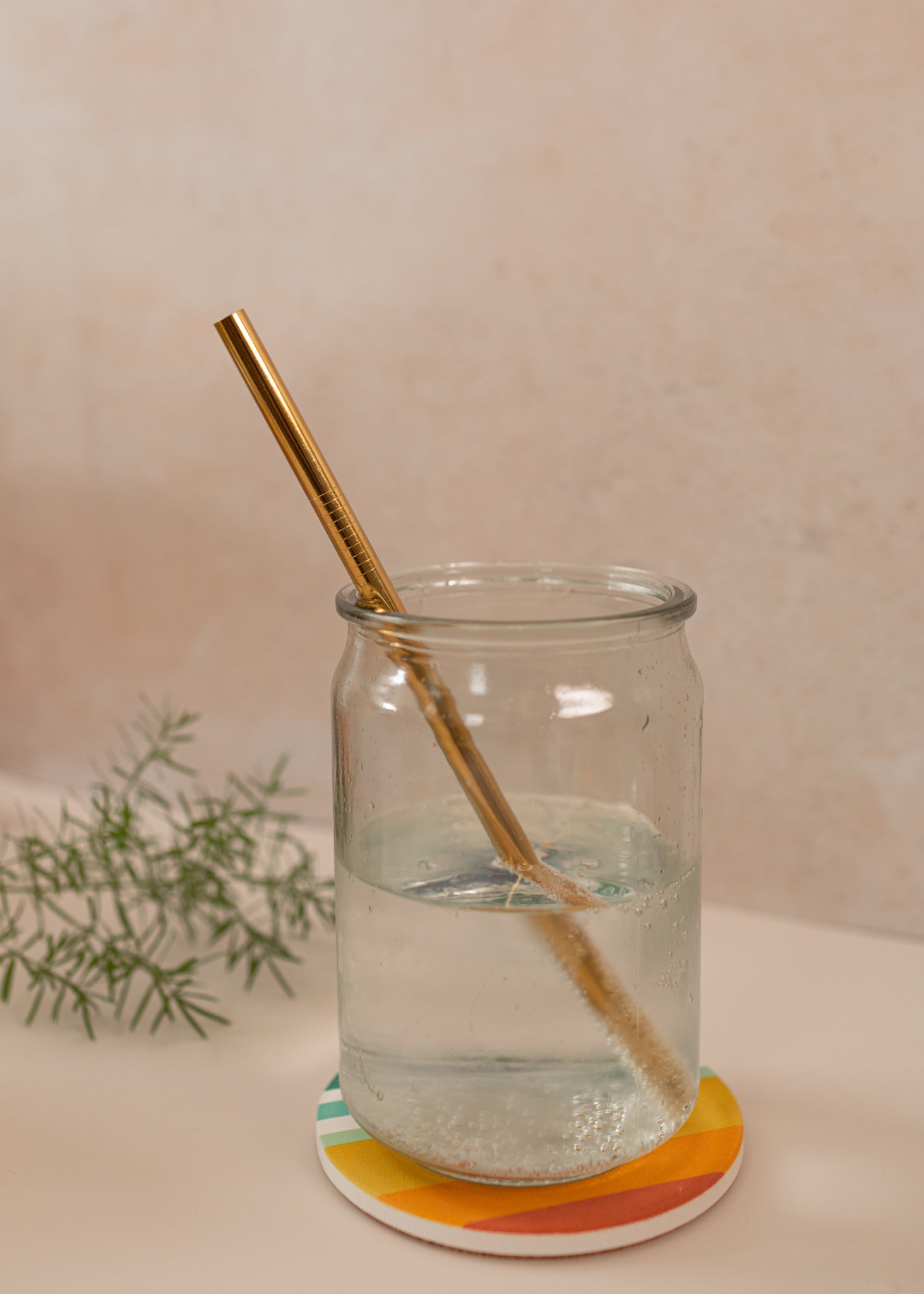 photo of a straight, gold reusable straw in a mason jar