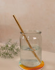 photo of a straight, gold reusable straw in a mason jar