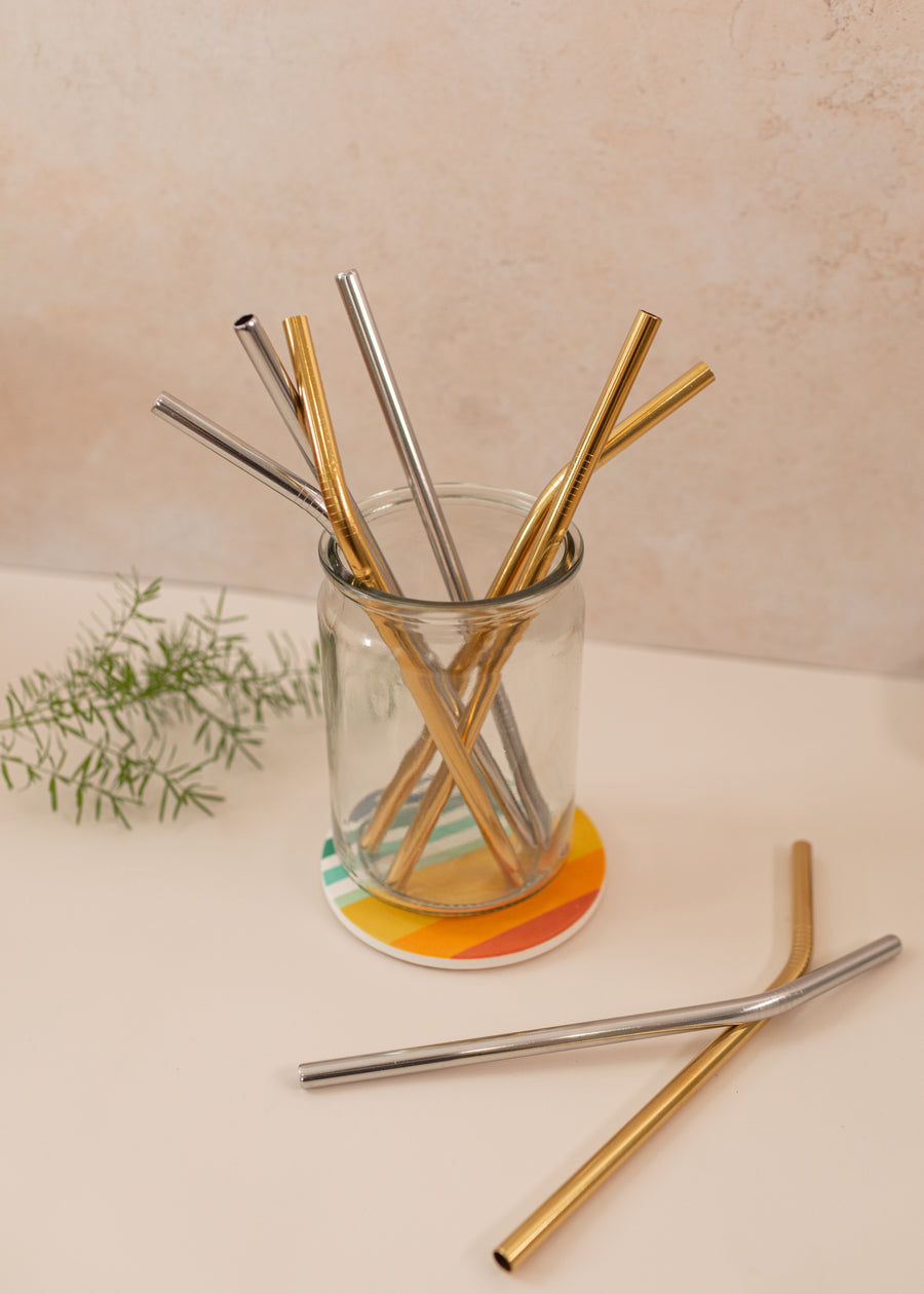 mason jar of a variety of reusable straws in silver and gold