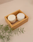 Photo of a shampoo and conditioner bar in a wooden dish tray